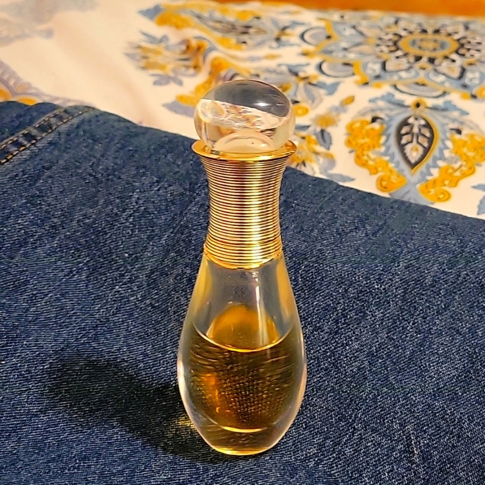 Pre-owned J'adore perfume in a roller pearl.06 bottle is about half full.